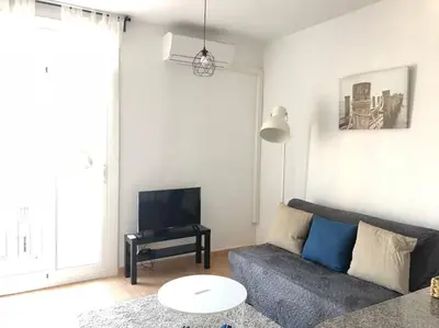 a living room with a couch and a tv at Nice 2 rooms apartment in the heart of barcelona in Barcelona