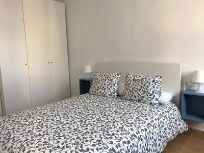 a bedroom with a black and white bed with two pillows at Nice 2 rooms apartment in the heart of barcelona in Barcelona