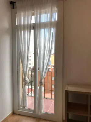 a large window with white curtains in a room at Nice 2 rooms apartment in the heart of barcelona in Barcelona