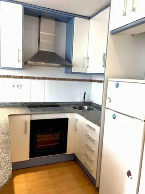 a kitchen with white cabinets and a sink and a stove at Nice 2 rooms apartment in the heart of barcelona in Barcelona