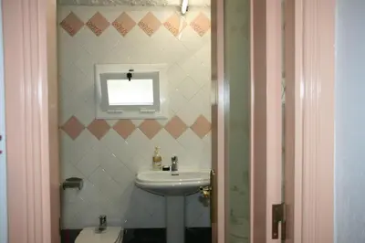 a bathroom with a sink and a window at MASIA CAN SUNYER AGROTURISMO in La Garriga