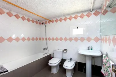 a bathroom with a toilet and a sink at MASIA CAN SUNYER AGROTURISMO in La Garriga