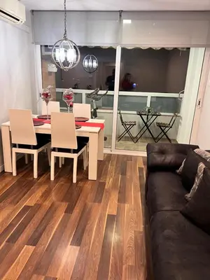 a living room with a table and a couch at Ca la Noa in Viladecáns