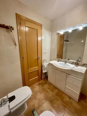 a bathroom with a toilet and a sink and a mirror at Casa con piscina Sant Pol de Mar in San Pol de Mar
