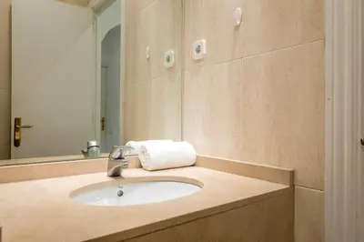 a bathroom with a sink and a mirror at Bebarceloner Poble Nou Apartaments - 2 bedroom in Barcelona