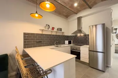 a kitchen with a stainless steel refrigerator and a counter at BeBarceloner Sants Apartments - 2 bedrooms in Barcelona