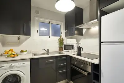 a kitchen with a sink and a washing machine at BeBarceloner Sant Andreu Apartments - 3 bedrooms in Barcelona