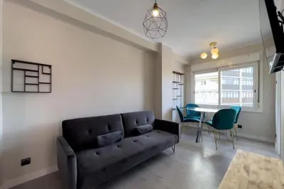a living room with a couch and a table at BeBarceloner Sant Andreu Apartments - 3 bedrooms in Barcelona