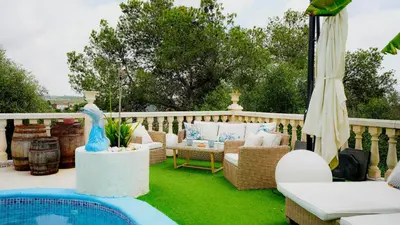 a patio with chairs and a pool on a deck at La Casa de Mima in Cubelles