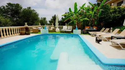 a swimming pool with lounge chairs and a resort at La Casa de Mima in Cubelles