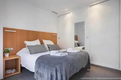 a bedroom with a large bed with towels on it at Flateli Navas D02 in Barcelona