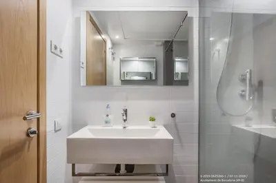 a white bathroom with a sink and a shower at Flateli Navas D02 in Barcelona