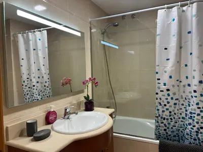 a bathroom with a sink and a shower at Cozy Beach House with Pool & BBQ in Cubelles