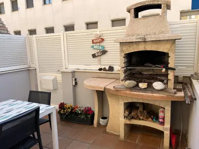a outdoor pizza oven sitting on top of a patio at Cozy Beach House with Pool & BBQ in Cubelles