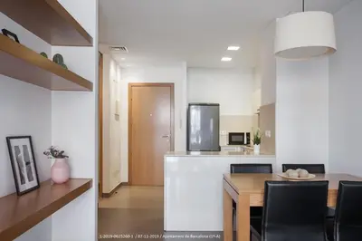 a kitchen and dining room with a table and chairs at Flateli Navas A01 in Barcelona