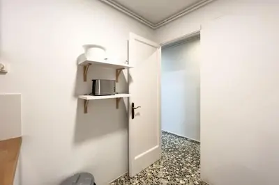 a room with a door and a microwave on the wall at BeBarceloner Eixample Apartments - 3 bedrooms in Barcelona