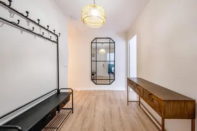 a hallway with a table and a living room at BeBarceloner Eixample Apartments- 4 bedrooms in Barcelona
