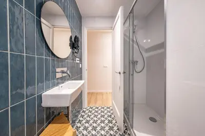 a bedroom with a bed and a mirror at BeBarceloner Eixample Apartments- 4 bedrooms in Barcelona