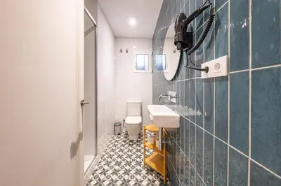 a row of beds in a room at BeBarceloner Eixample Apartments- 4 bedrooms in Barcelona