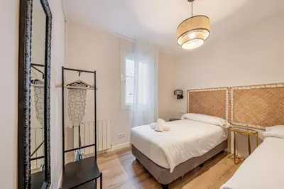 two beds in a room with green and white at BeBarceloner Eixample Apartments- 4 bedrooms in Barcelona