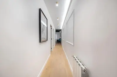 a bedroom with a bed and a desk and a chair at BeBarceloner Eixample Apartments - 4 bedrooms in Barcelona