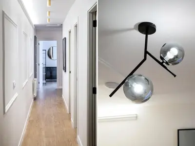 a hallway of a bathroom with a sink and a mirror at BeBarceloner Eixample Apartments - 4 bedrooms in Barcelona