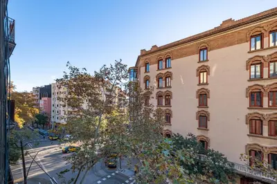 a hotel room with two beds and a mirror at BeBarceloner Eixample Apartments - 4 bedrooms in Barcelona