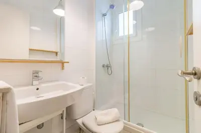 a bathroom with a toilet and a sink and a shower at BeBarceloner Sant Andreu Apartments - Attic with terrace in Barcelona