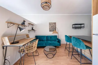 a living room with a blue couch and chairs at BeBarceloner Sant Andreu Apartments - 1 bedroom with terrace in Barcelona