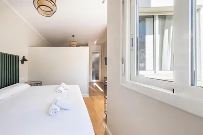 a bedroom with a white bed and a window at BeBarceloner Sant Andreu Apartments - 1 bedroom with terrace in Barcelona
