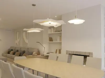 a dining room with a table and white chairs at Sitges Spaces Bonaire Beach Condo in Sitges