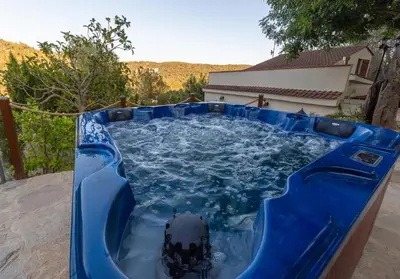 a large blue pool with a black object in it at SILOM HOUSE in Sant Pere de Ribes