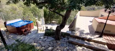 a bath tub in a yard next to a tree at SILOM HOUSE in Sant Pere de Ribes
