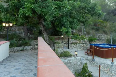 a pathway with a table and a bench and a tree at SILOM HOUSE in Sant Pere de Ribes