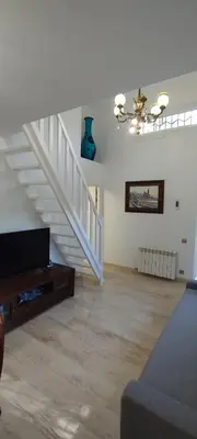 a living room with a staircase and a couch at SILOM HOUSE in Sant Pere de Ribes