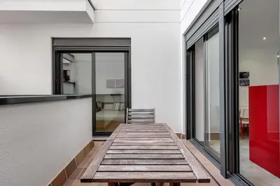 a hallway with a wooden bench in a building at Urban Flats Vallirana in Barcelona