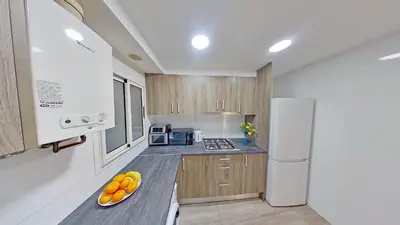a kitchen with a plate of fruit on a counter at PREMIUM HABITAT LA RIERA in Pineda de Mar