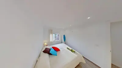 a white room with a bed and a window at PREMIUM HABITAT LA RIERA in Pineda de Mar