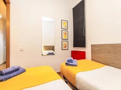 a bedroom with two beds and a mirror at Apartment Sants-Montjuïc- Avenida Madrid by Interhome in Barcelona