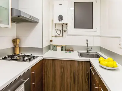 a kitchen with a sink and a bowl of fruit on the counter at Apartment Sants-Montjuïc- Avenida Madrid by Interhome in Barcelona