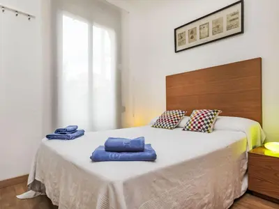 a bedroom with a large bed with blue towels on it at Apartment Sants-Montjuïc- Avenida Madrid by Interhome in Barcelona