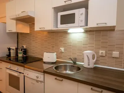 a kitchen with a sink and a microwave at Apartment Sagrada Familia- Rossello by Interhome in Barcelona