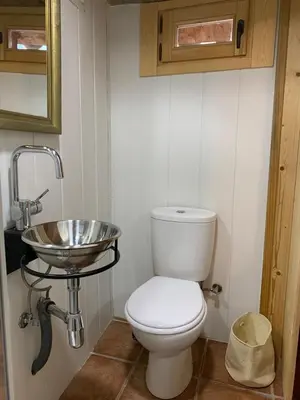 a bathroom with a toilet and a sink at Cal General in San Vicente de Castellet