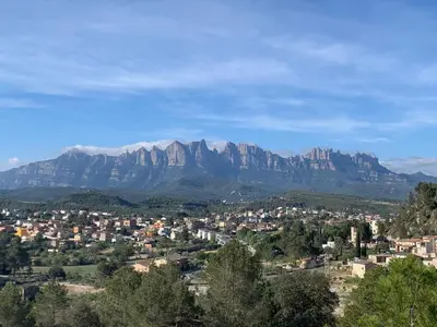 a view of a city with mountains in the background at Cal General in San Vicente de Castellet