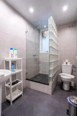 a bathroom with a sink and a mirror at The Collection Barcelona - Eixample - Bright and modern 4BD only for Families or Business groups in Barcelona