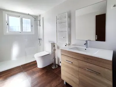 a bathroom with a sink and a toilet and a mirror at Casa con piscina privada en Sant Pol de Mar in San Pol de Mar