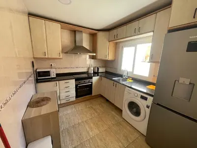 a small kitchen with a washer and dryer in it at Apartamentos Atlas Terrassa V in Terrassa