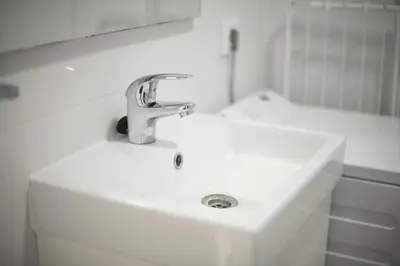a white bathroom sink with a faucet on it at Ático en Calella a 7 minutos de la playa in Calella