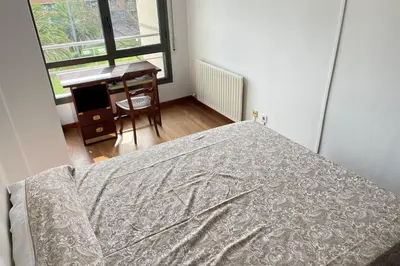 a bedroom with a bed and a desk and a window at Apartment with sea views next to the beach of Mar Bella in Barcelona